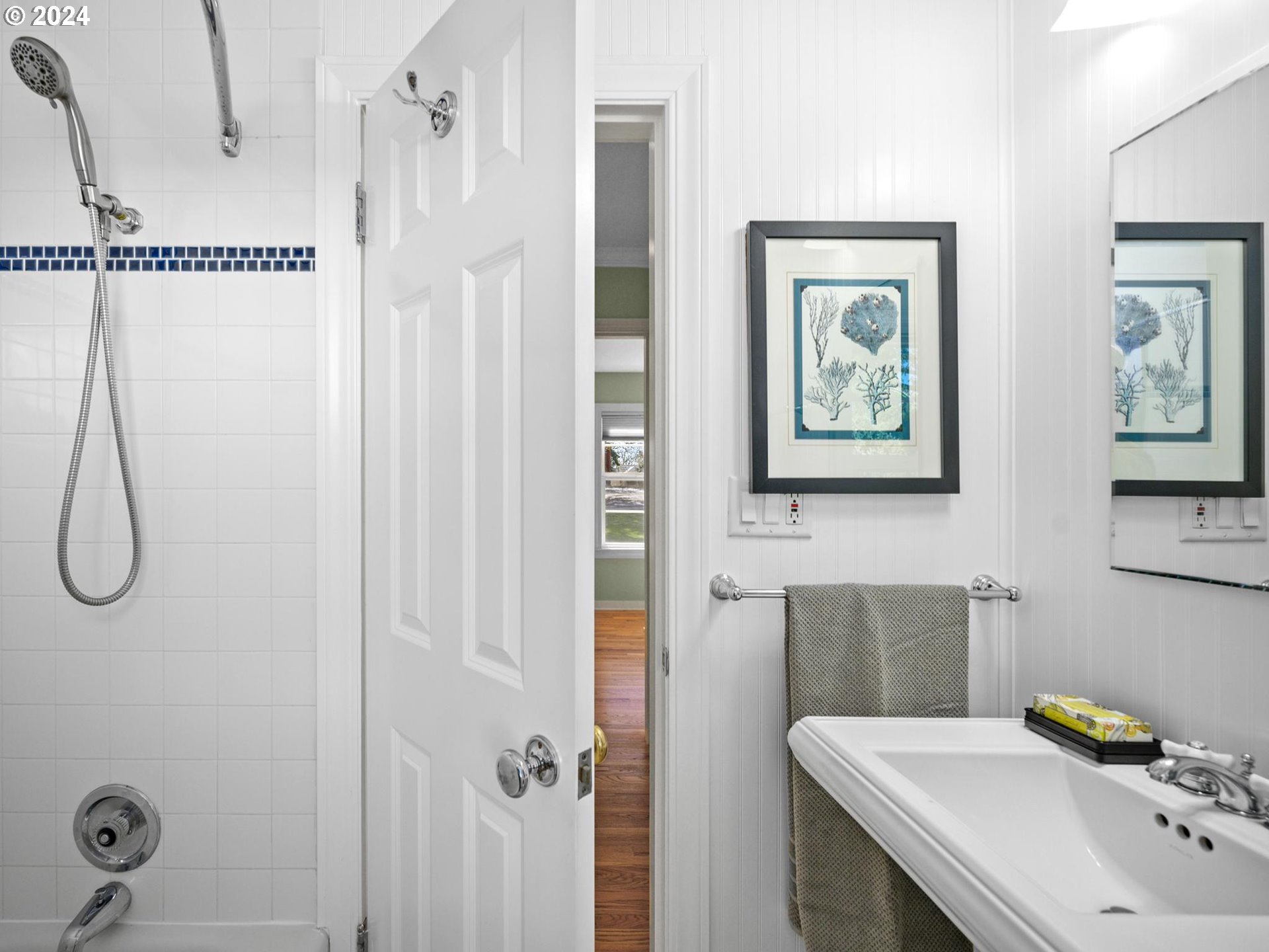 6435 Southwest Brugger Street Portland, OR 97219 - Photo 21 of 43 a bathroom with a sink and mirror