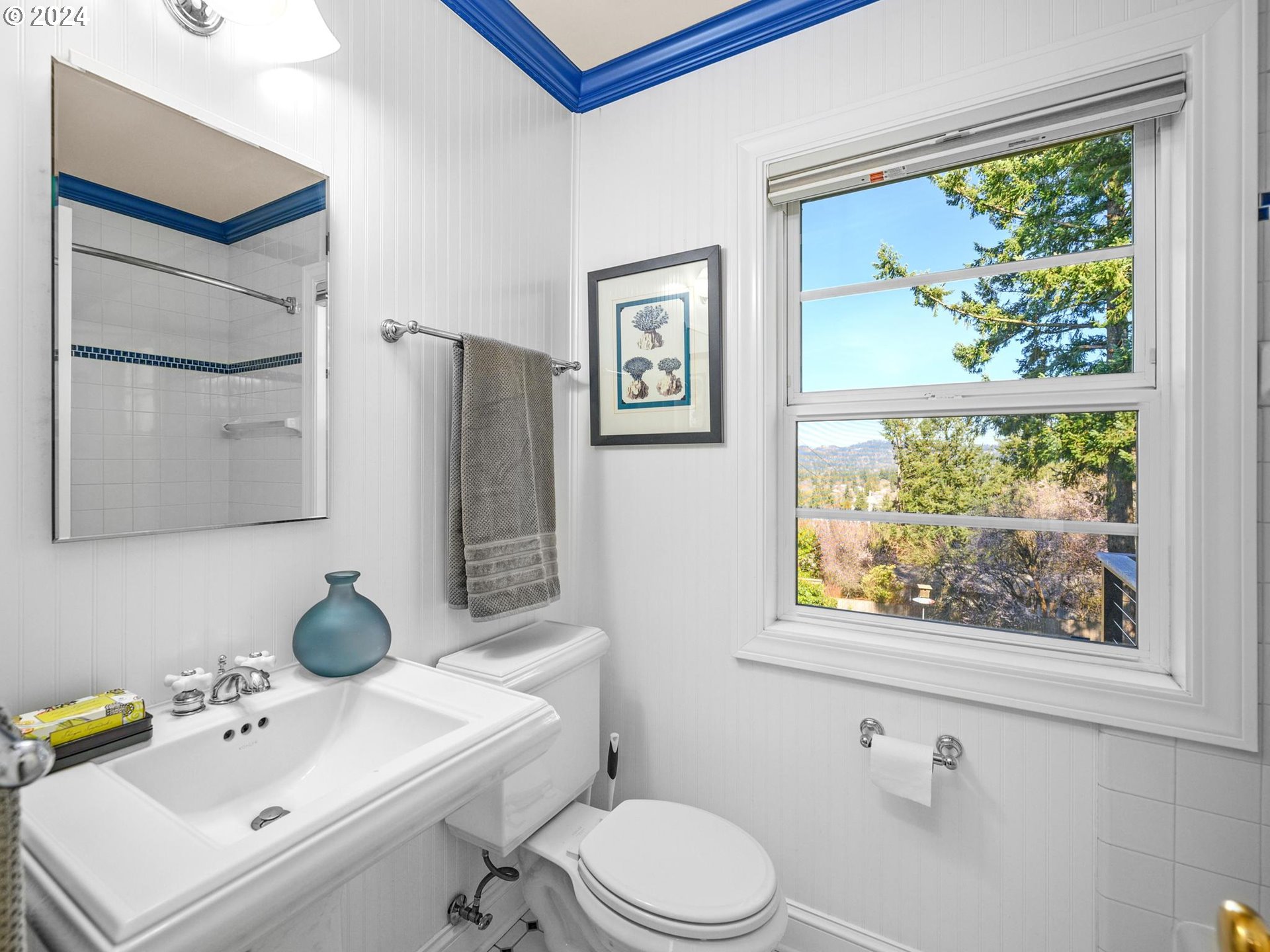 6435 Southwest Brugger Street Portland, OR 97219 - Photo 22 of 43 a bathroom with a toilet a sink and mirror