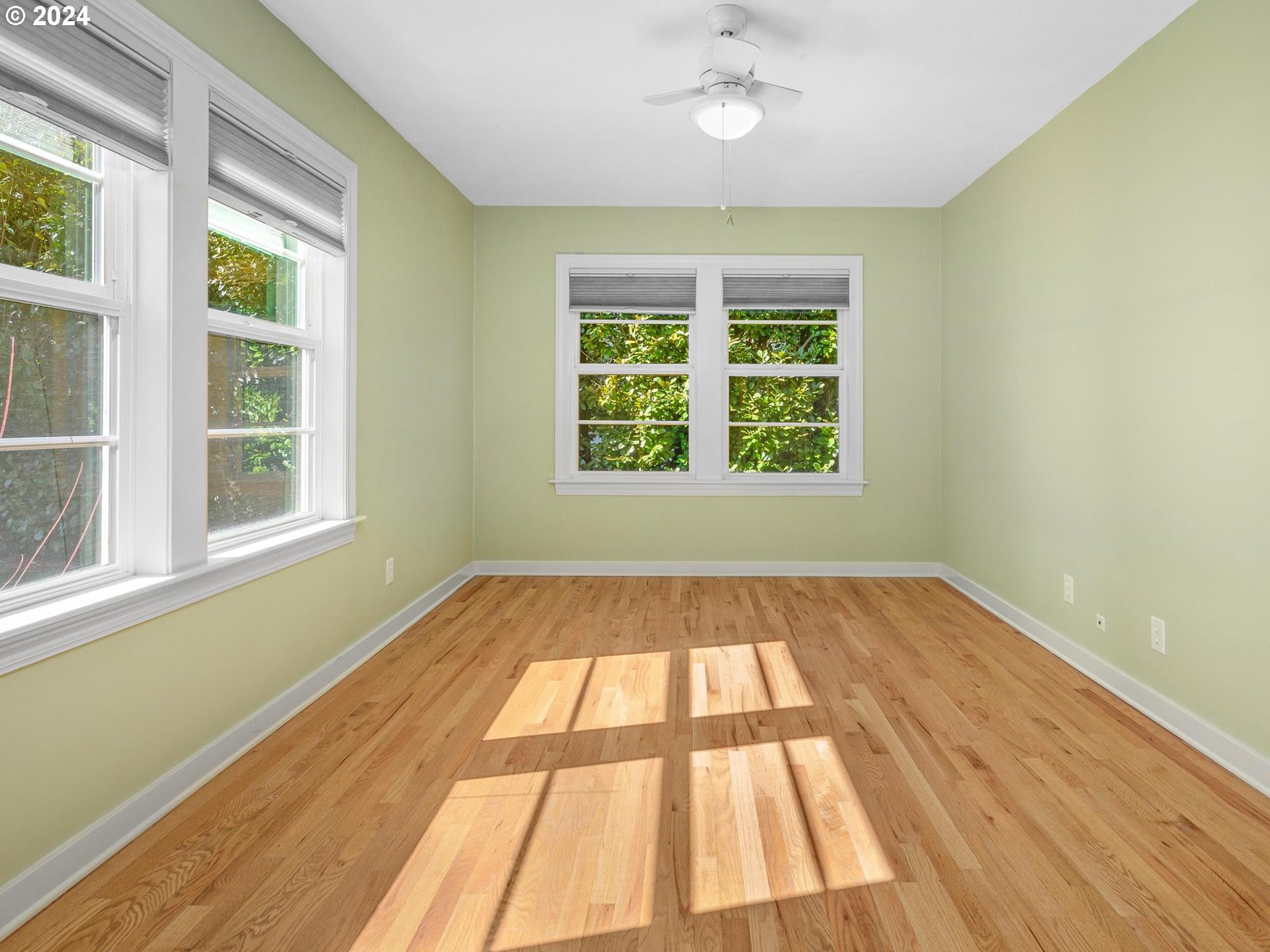 6435 Southwest Brugger Street Portland, OR 97219 - Photo 23 of 43 an empty room with wooden floor and windows