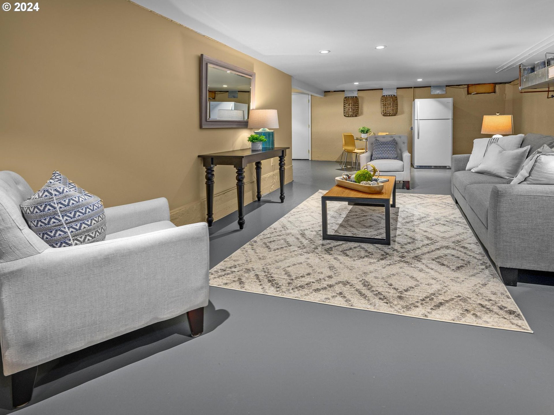 6435 Southwest Brugger Street Portland, OR 97219 - Photo 25 of 43 a living room with furniture and a rug