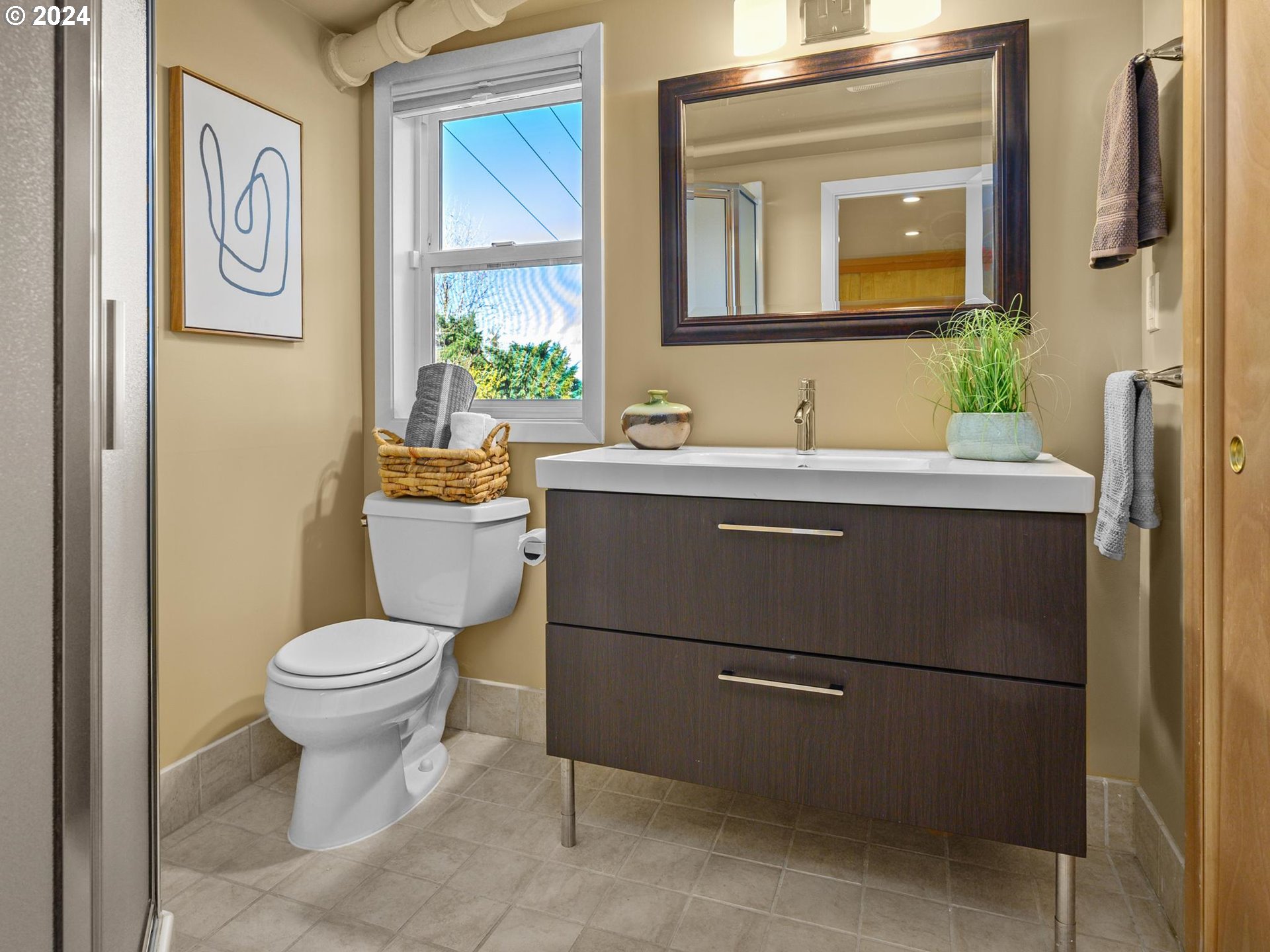 6435 Southwest Brugger Street Portland, OR 97219 - Photo 33 of 43 a bathroom with a toilet sink and mirror