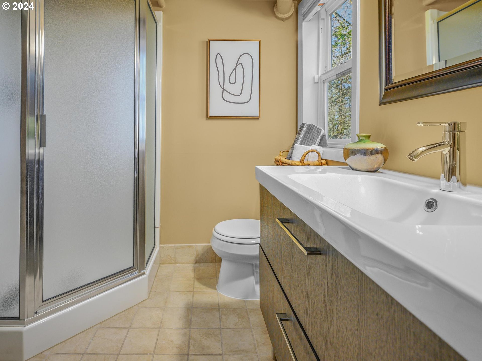 6435 Southwest Brugger Street Portland, OR 97219 - Photo 34 of 43 a bathroom with a sink a toilet and mirror