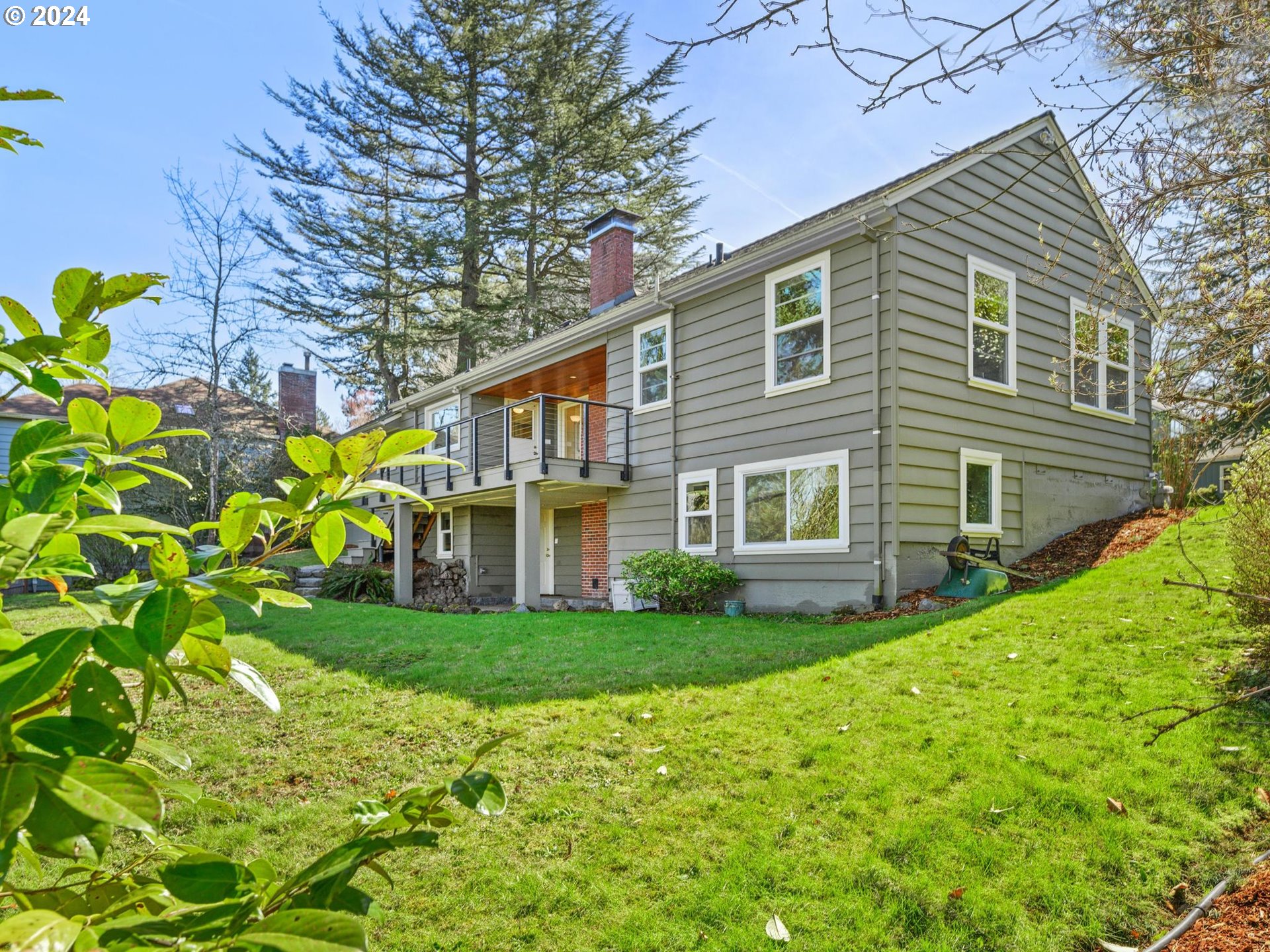 6435 Southwest Brugger Street Portland, OR 97219 - Photo 36 of 43 a view of a house with a yard and sitting area