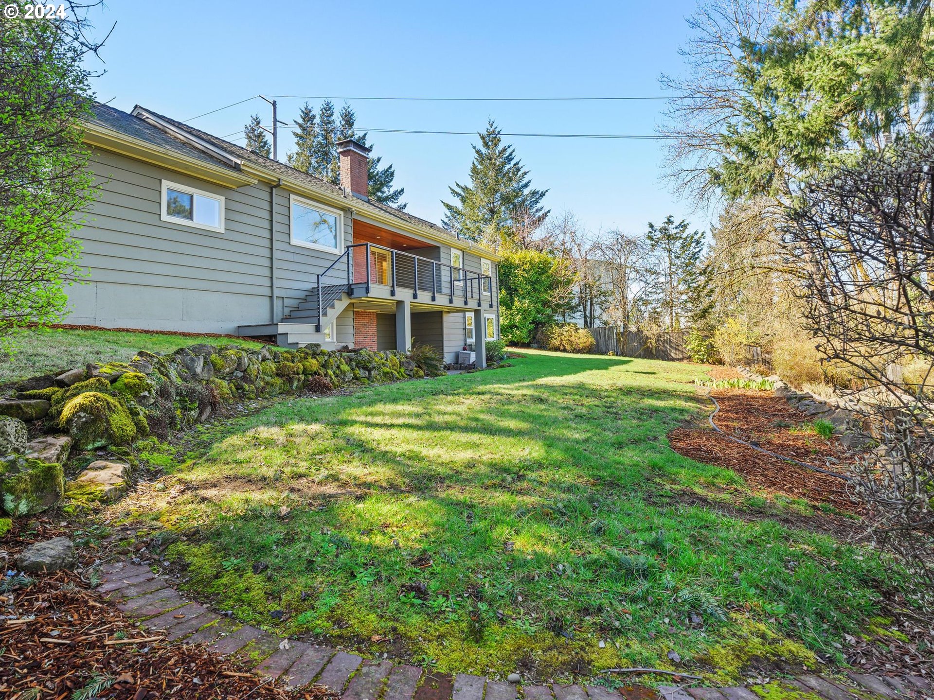 6435 Southwest Brugger Street Portland, OR 97219 - Photo 40 of 43 a front view of a house with a yard