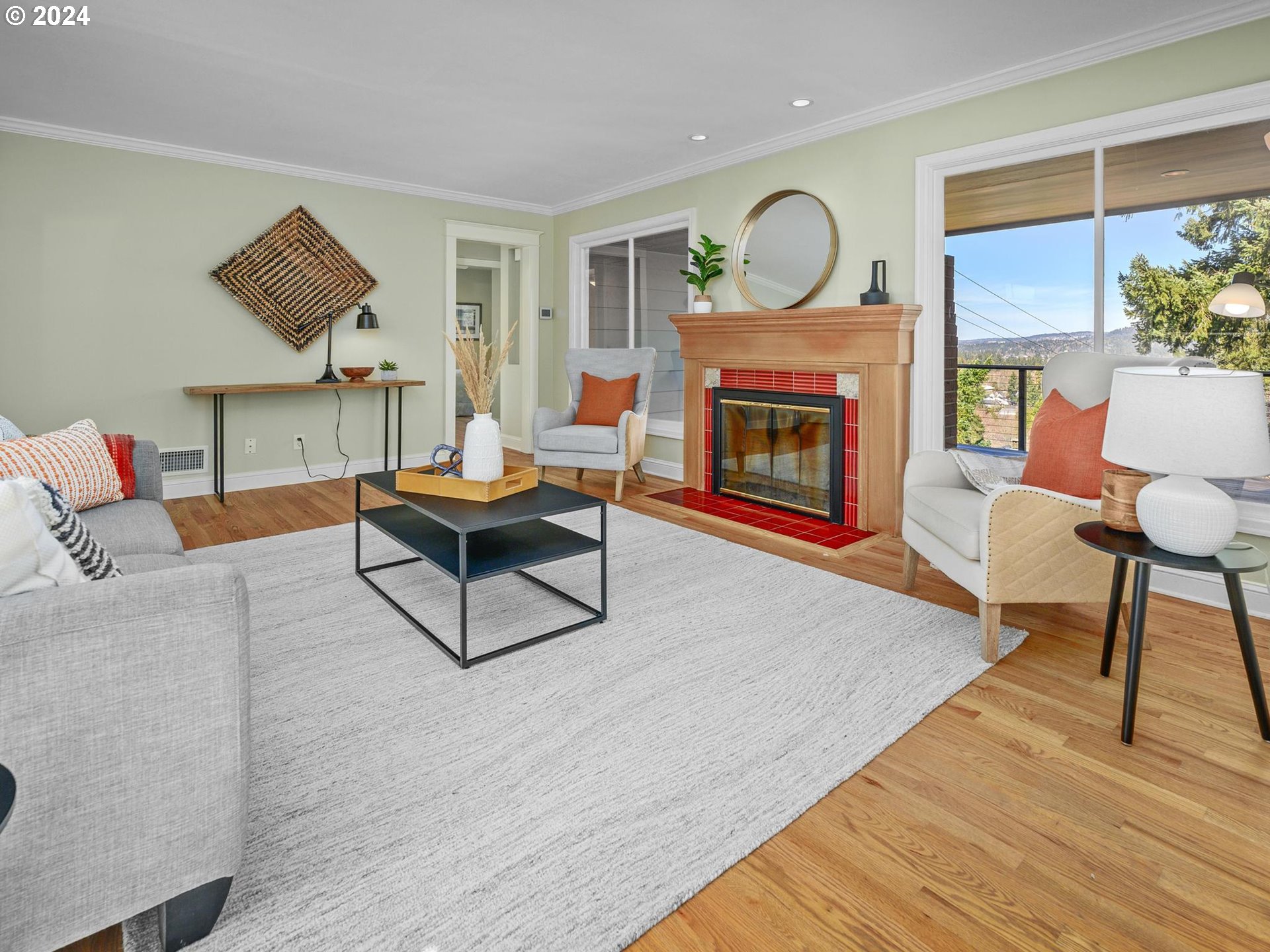 6435 Southwest Brugger Street Portland, OR 97219 - Photo 4 of 43 a living room with furniture a fireplace and a large window
