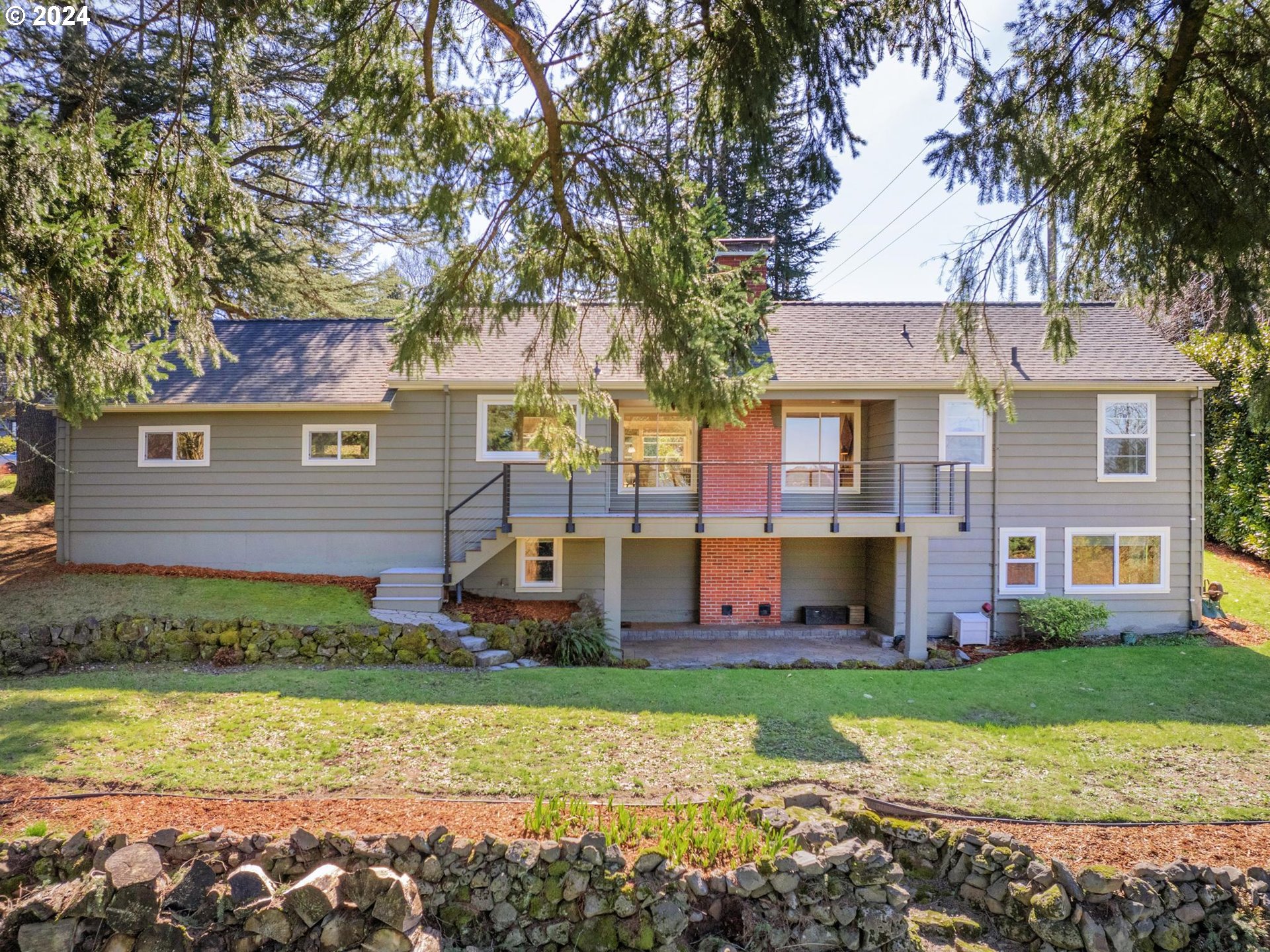 6435 Southwest Brugger Street Portland, OR 97219 - Photo 41 of 43 a front view of a house with garden