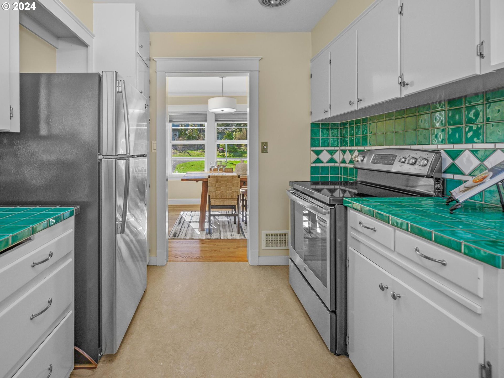 6435 Southwest Brugger Street Portland, OR 97219 - Photo 9 of 43 a kitchen with stainless steel appliances granite countertop a stove and a refrigerator