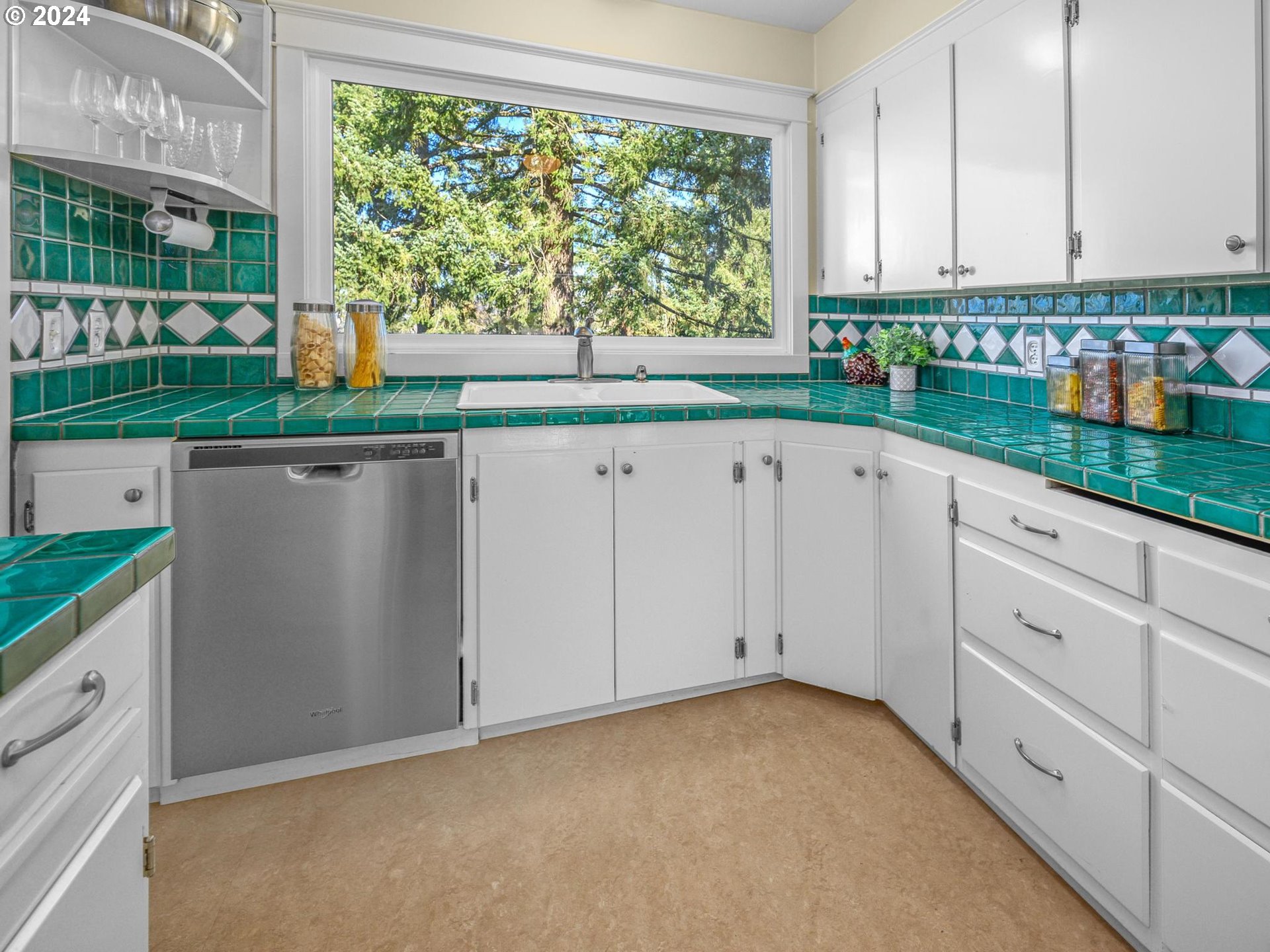6435 Southwest Brugger Street Portland, OR 97219 - Photo 10 of 43 a view of a kitchen with kitchen island and windows