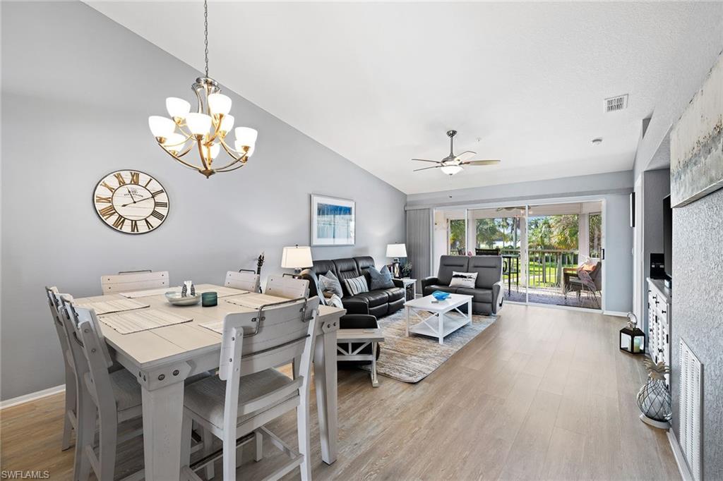 9022 Michael Circle, Unit 4 Naples, FL 34113 - Photo 11 of 28 a living room with furniture dining table and a large window