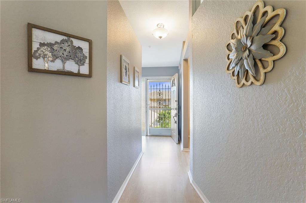 9022 Michael Circle, Unit 4 Naples, FL 34113 - Photo 21 of 28 a view of a hallway with interior of the house