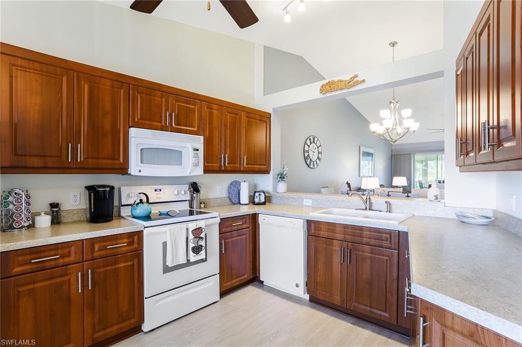 9022 Michael Circle, Unit 4 Naples, FL 34113 - Photo 22 of 28 a kitchen with a sink stove and cabinets