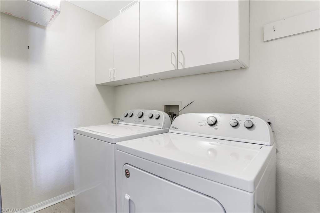 9022 Michael Circle, Unit 4 Naples, FL 34113 - Photo 25 of 28 a utility room with dryer and washer