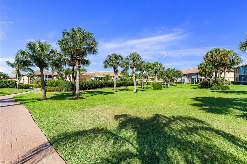 9022 Michael Circle, Unit 4 Naples, FL 34113 - Photo 5 of 28 a view of a golf course with a garden