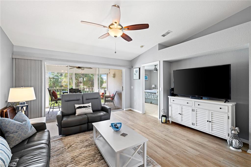 9022 Michael Circle, Unit 4 Naples, FL 34113 - Photo 9 of 28 a living room with furniture and a flat screen tv
