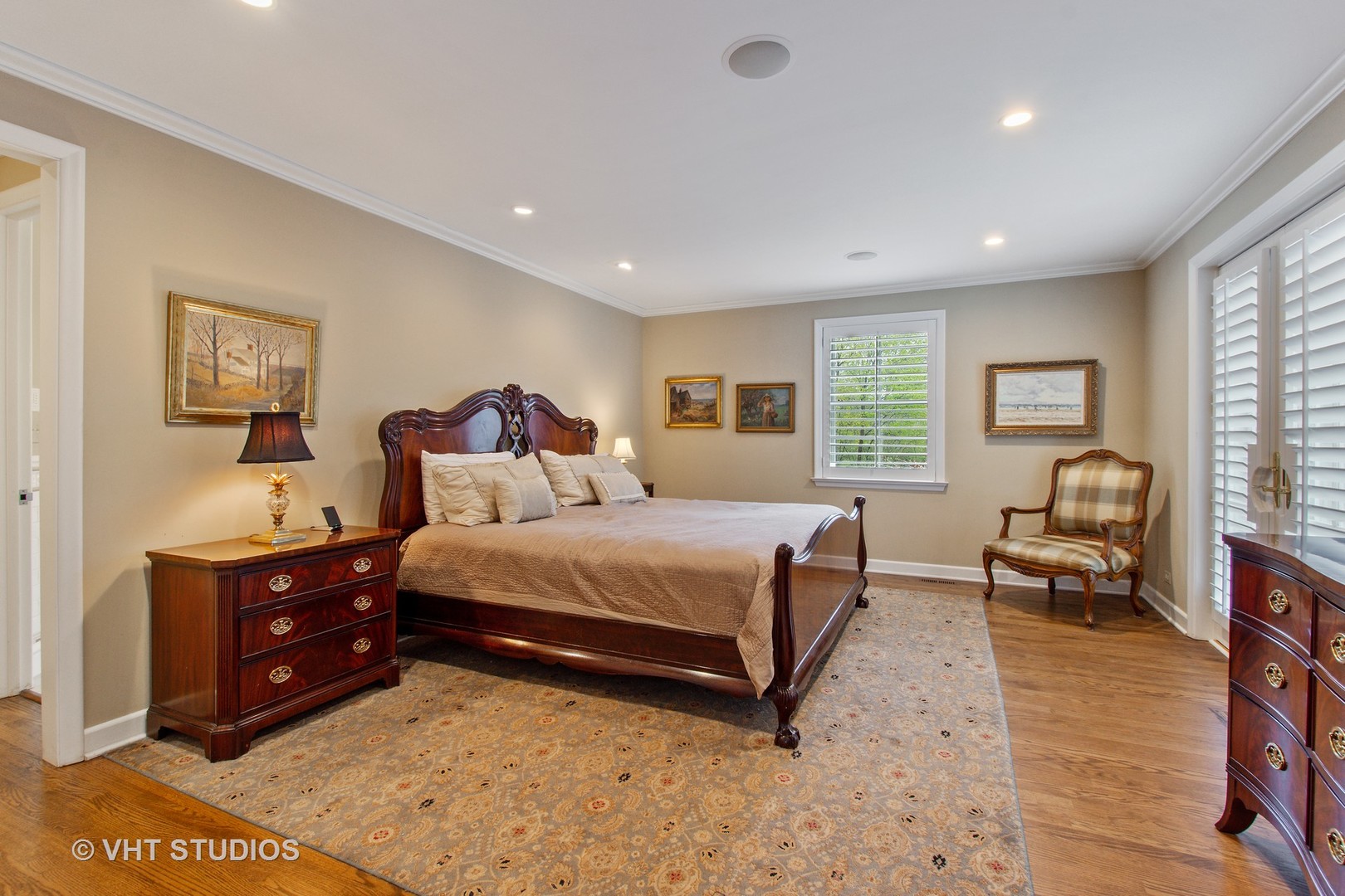 570 Aberdeen Road Inverness, IL 60067 - Photo 11 of 34 a spacious bedroom with a bed a couch and a dresser with wooden floor