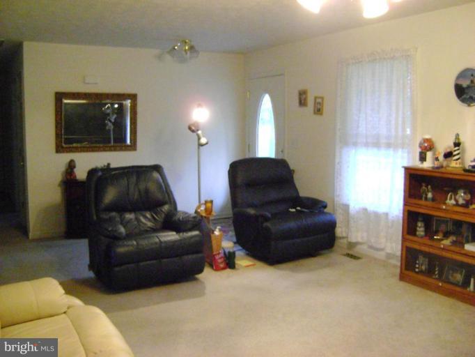17868 Piney Point Road Tall Timbers, MD 20690 - Photo 2 of 13 a living room with furniture and a couch