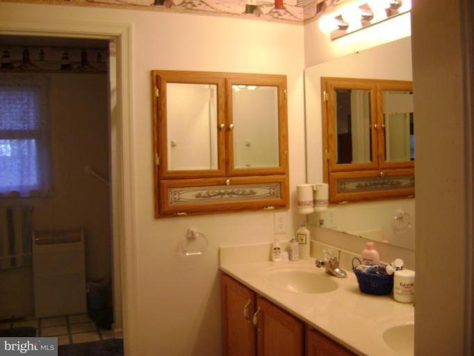 17868 Piney Point Road Tall Timbers, MD 20690 - Photo 5 of 13 a bathroom with a sink and a mirror