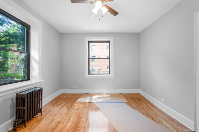 a view of a room with wooden floor and natural light