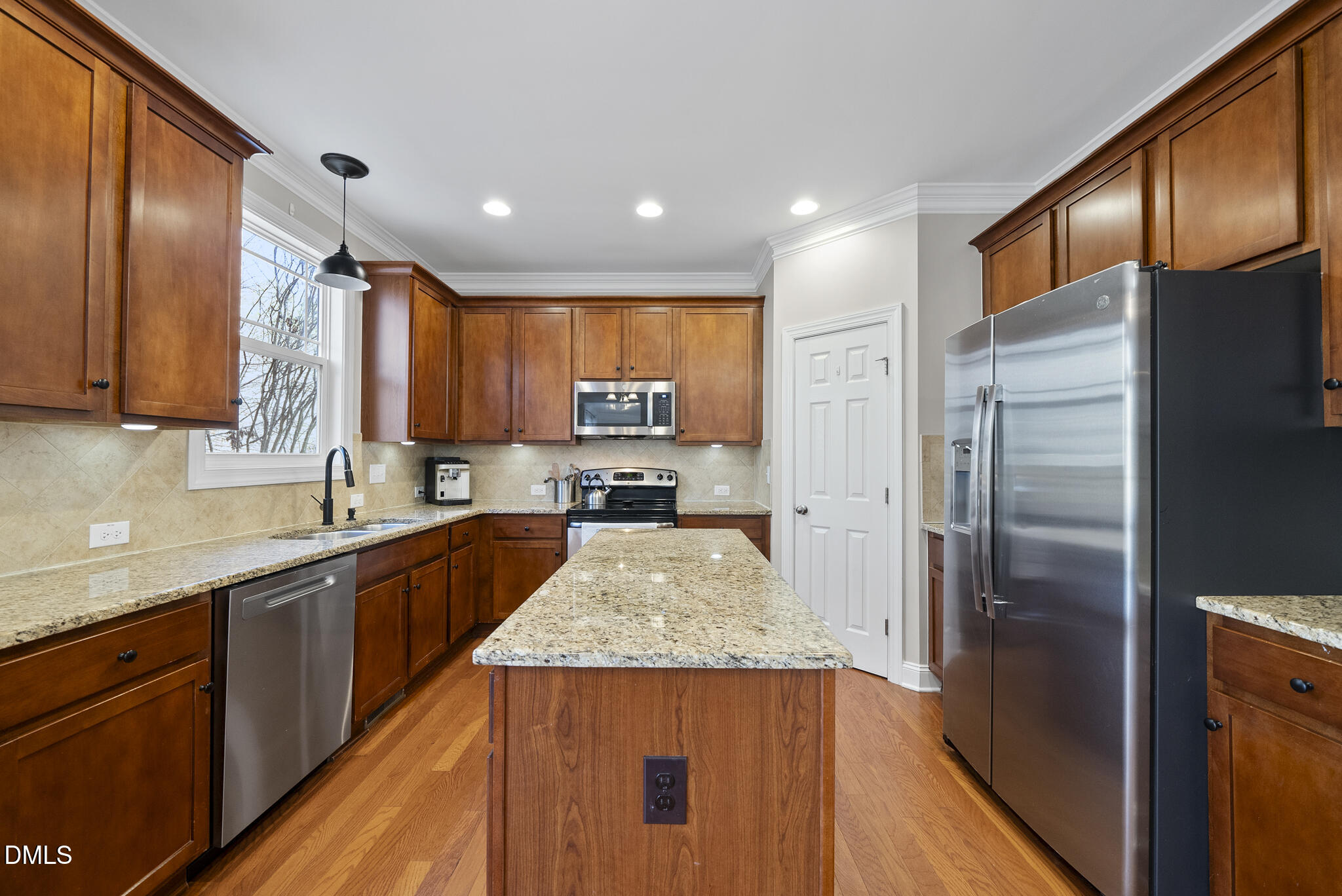 2731 Hidden Waters Circle Raleigh, NC 27614 - Photo 17 of 58 a kitchen with stainless steel appliances granite countertop wooden cabinets a refrigerator and a sink