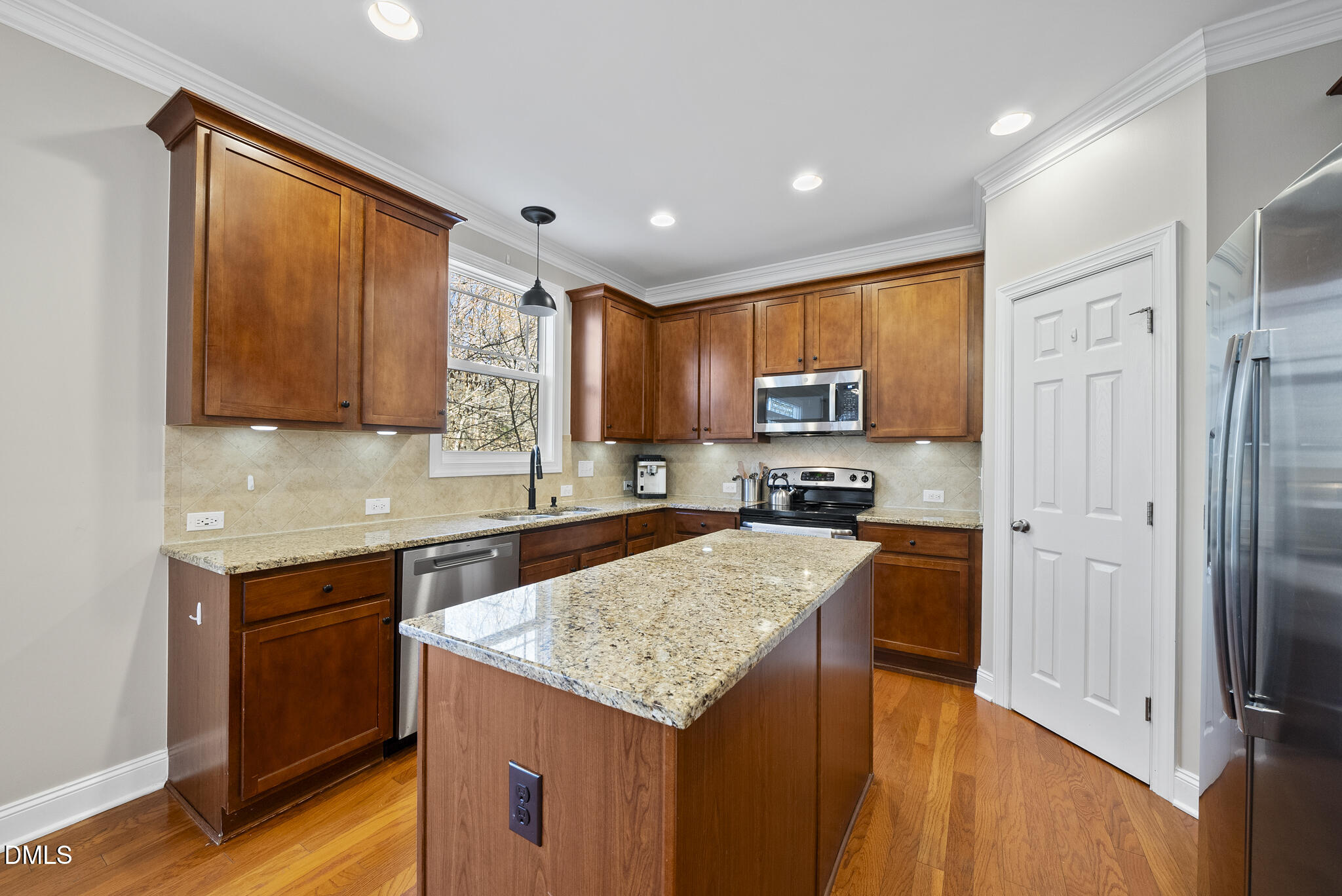 2731 Hidden Waters Circle Raleigh, NC 27614 - Photo 18 of 58 a kitchen with a sink a counter top space cabinets and stainless steel appliances