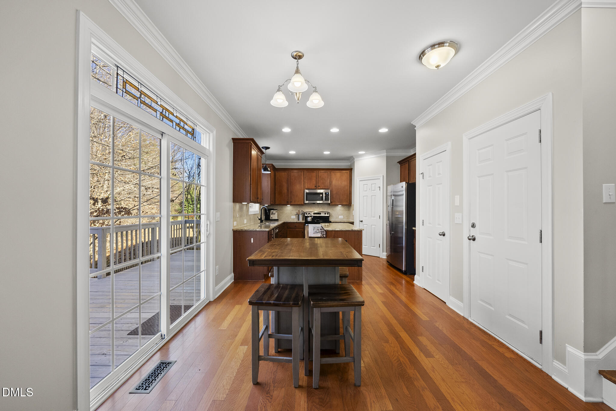 2731 Hidden Waters Circle Raleigh, NC 27614 - Photo 20 of 58 a view of a dining room with furniture a chandelier and wooden floor