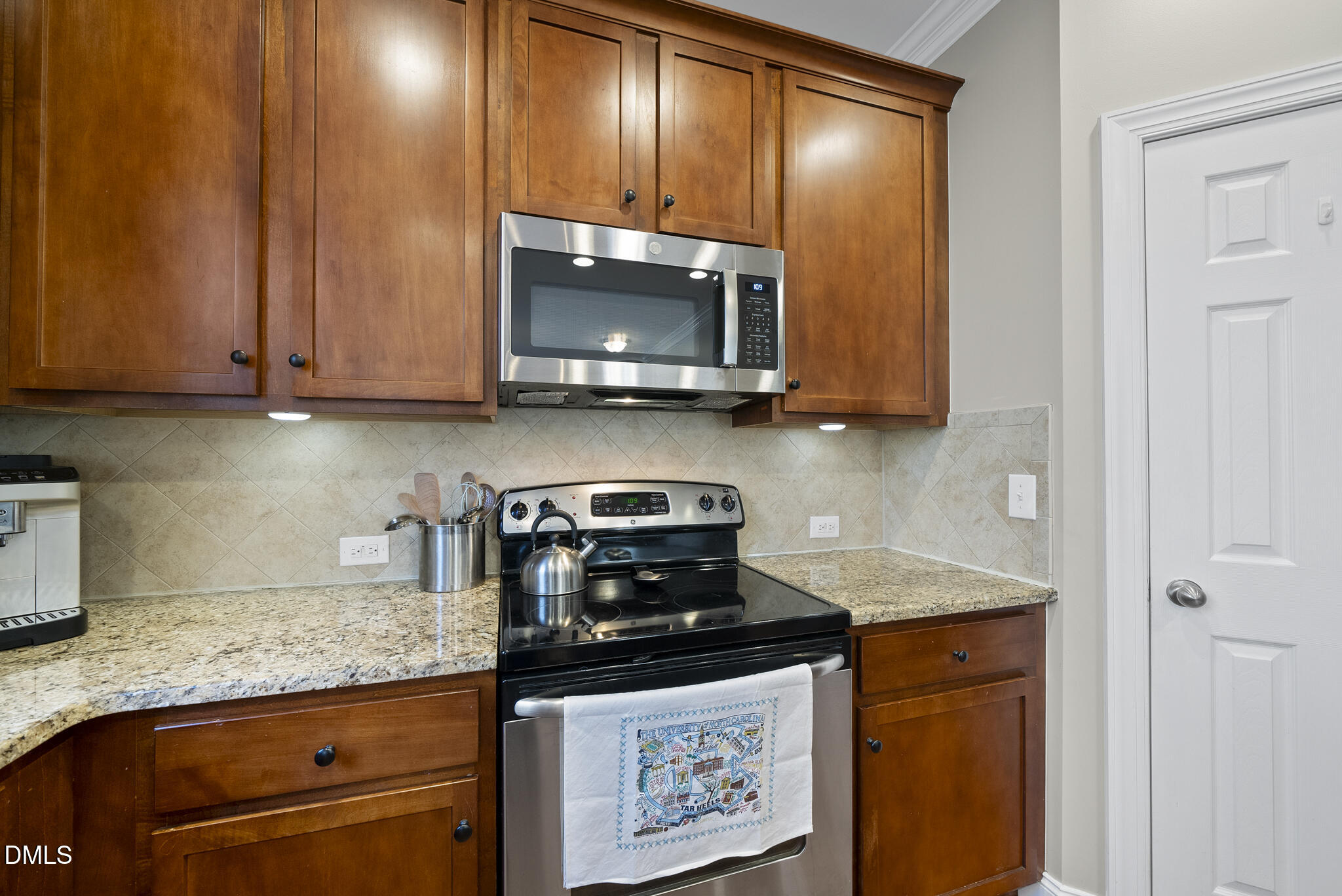 2731 Hidden Waters Circle Raleigh, NC 27614 - Photo 22 of 58 a kitchen with stainless steel appliances granite countertop a stove a sink and a microwave