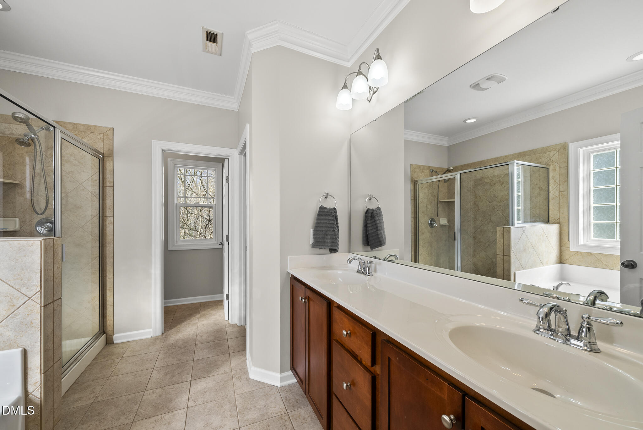 2731 Hidden Waters Circle Raleigh, NC 27614 - Photo 29 of 58 a spacious bathroom with a double vanity sink a mirror and shower
