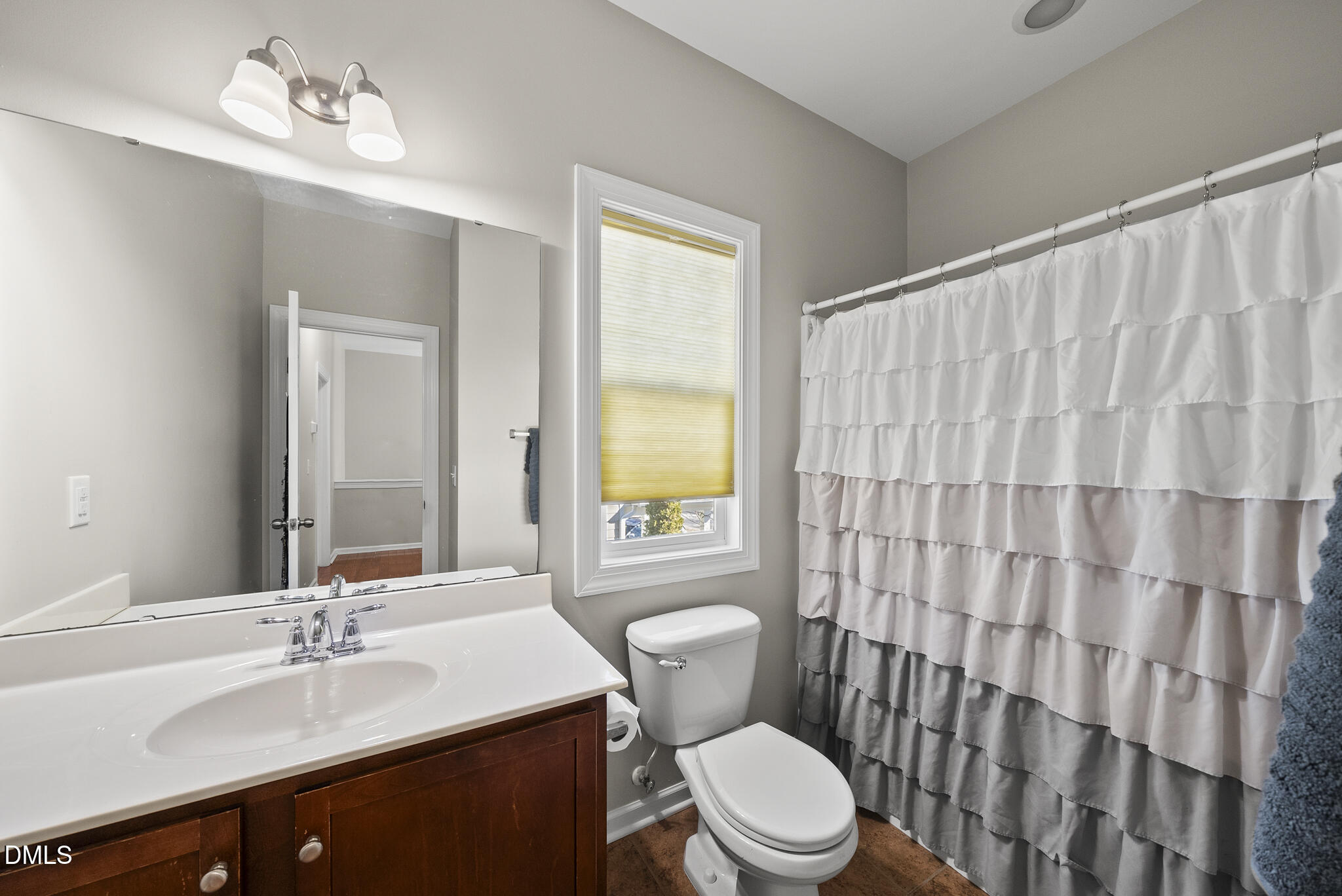 2731 Hidden Waters Circle Raleigh, NC 27614 - Photo 38 of 58 a bathroom with a sink a toilet and shower curtain