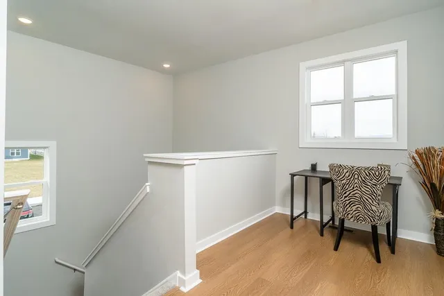 a view of a room with wooden floor and windows