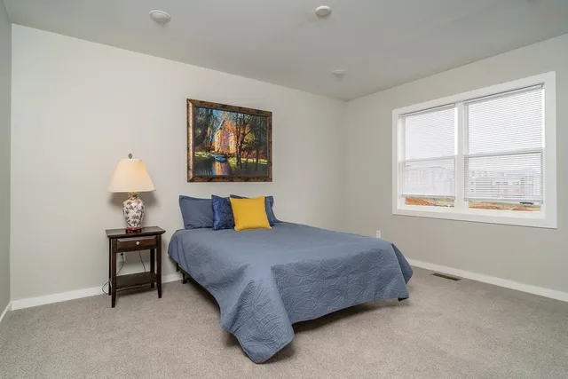 a bedroom with a bed and window