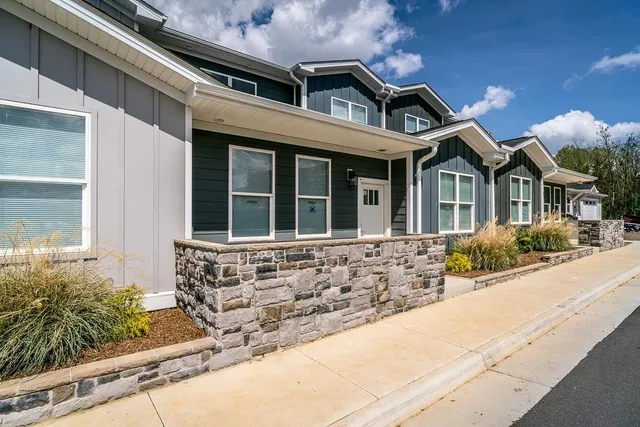 a view of a house with a swimming pool and a yard