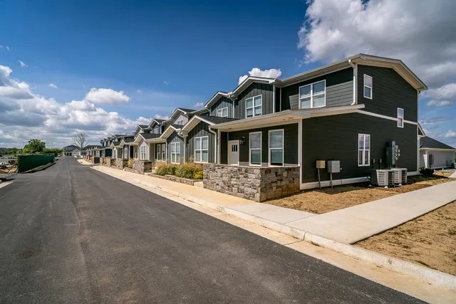 a front view of a house with sitting area