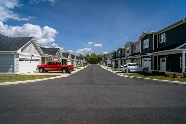 a view of a patio with a table and chairs under an umbrella