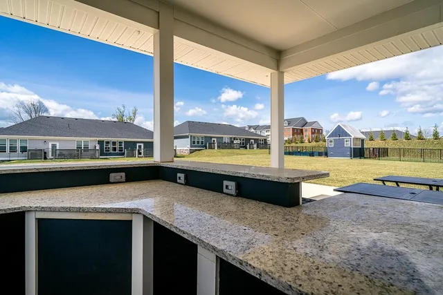 a view of a living room couch and a floor to ceiling window