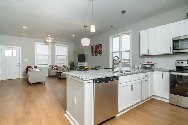 a kitchen with sink and white cabinets
