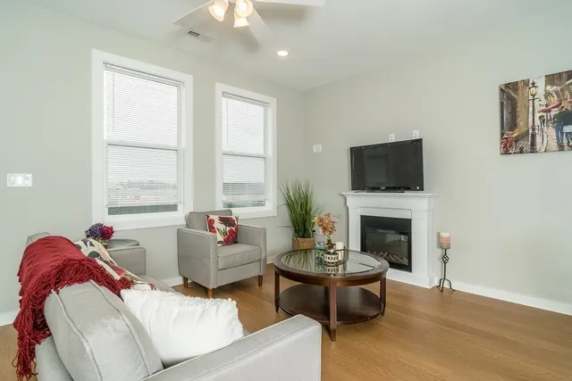 a living room with furniture fireplace and window