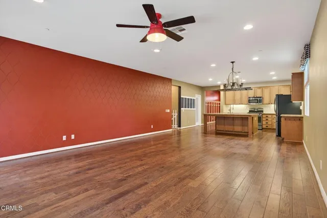 a view of kitchen with wooden floor and electronic appliances