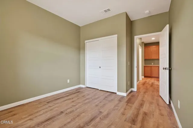 a view of a room with wooden floor