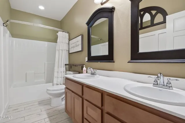 a bathroom with 2 sink and a mirror