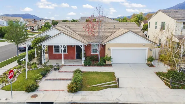 a front view of a house with a garden and plants