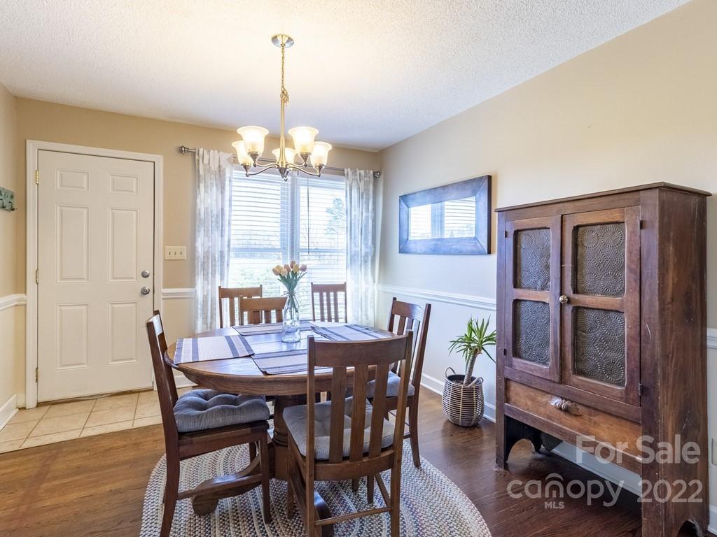 3209 Neal Boyce Road, Unit 11 Monroe, NC 28110 - Photo 12 of 41 a view of a dining room with furniture window and wooden floor