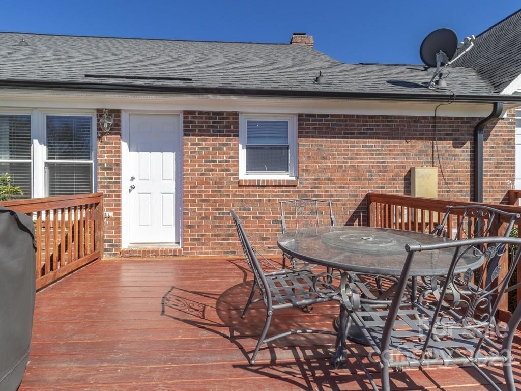 3209 Neal Boyce Road, Unit 11 Monroe, NC 28110 - Photo 35 of 41 a roof deck with wooden floor and fence