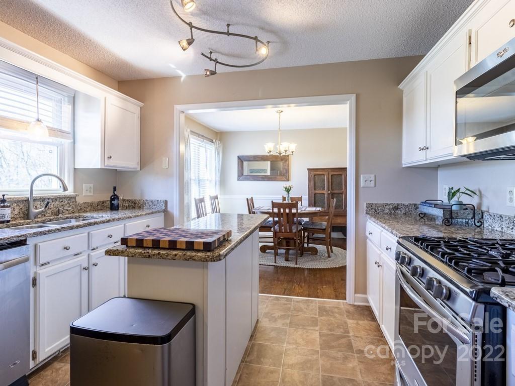 3209 Neal Boyce Road, Unit 11 Monroe, NC 28110 - Photo 5 of 41 a kitchen with stove and cabinets