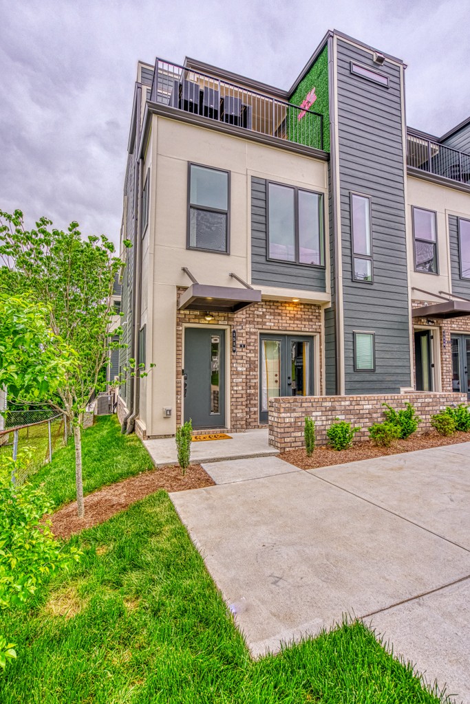 1519 Meridian Street, Unit 3 Nashville, TN 37207 - Photo 2 of 61 a front view of a house with a yard and potted plants