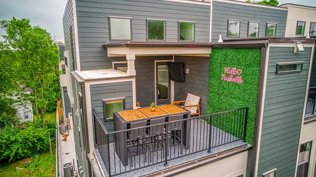 a view of a house with backyard and sitting area