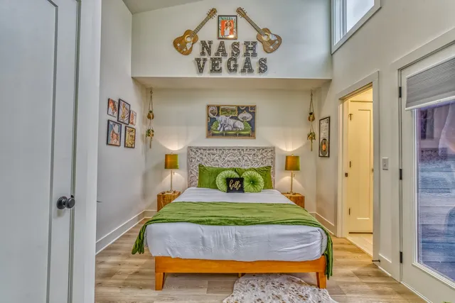 a bedroom with a bed and painting on the wall