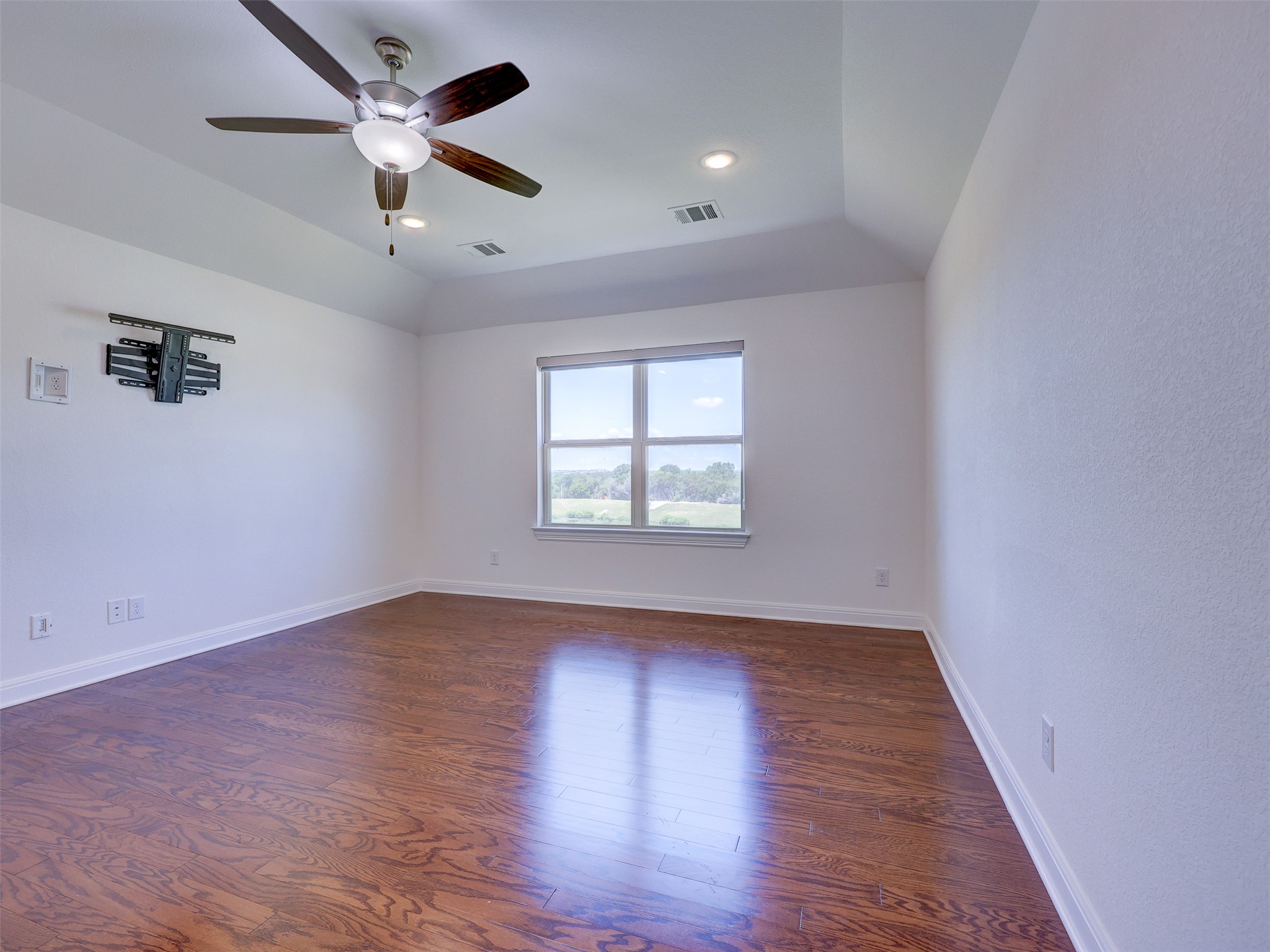 2020 Base Burner Path Leander, TX 78641 - Photo 13 of 22 Spare room featuring dark wood-type flooring, recessed lighting, lofted ceiling, and a ceiling fan