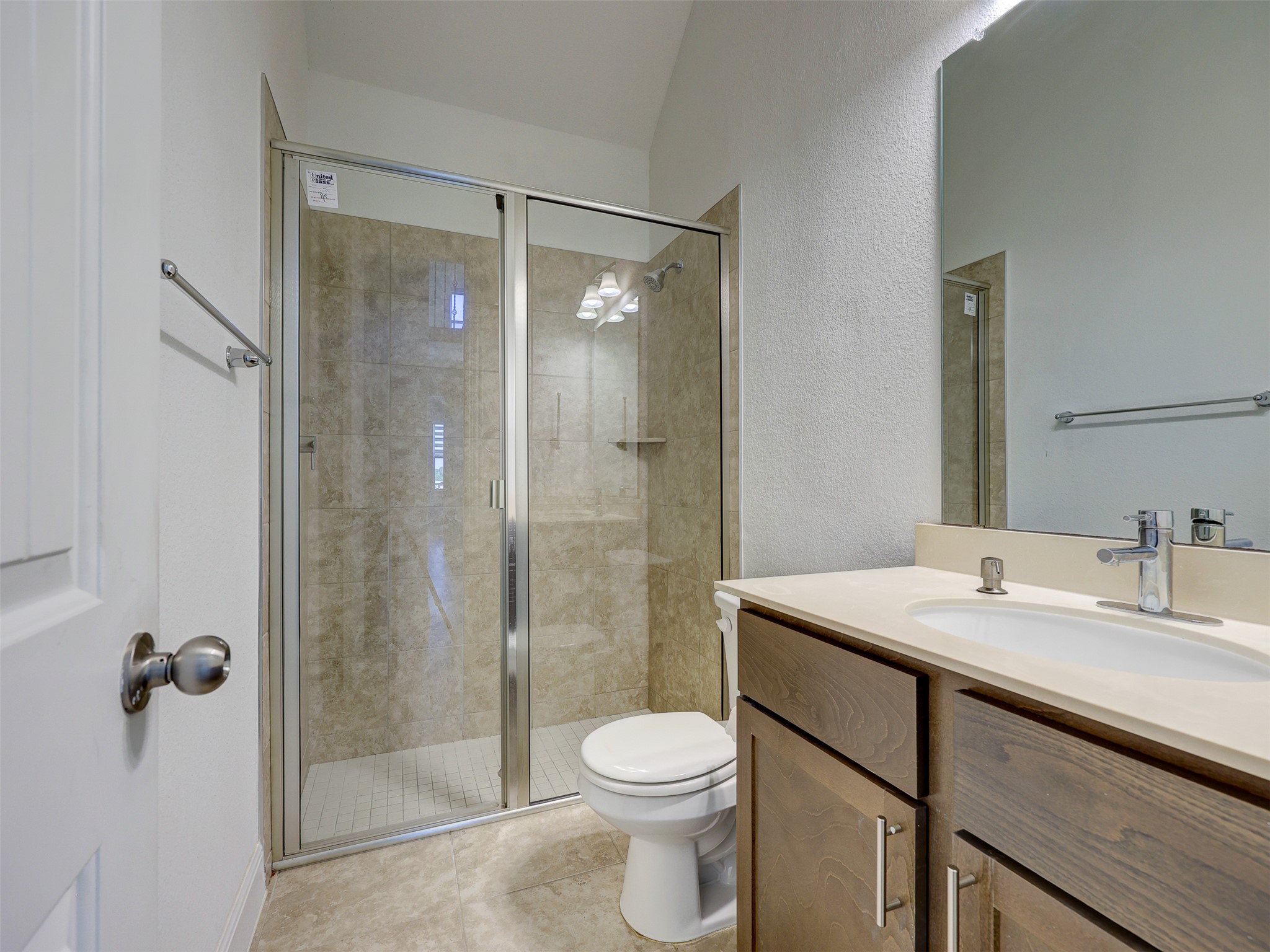 2020 Base Burner Path Leander, TX 78641 - Photo 14 of 22 Full bath featuring vanity, a textured wall, a shower stall, and light tile patterned floors