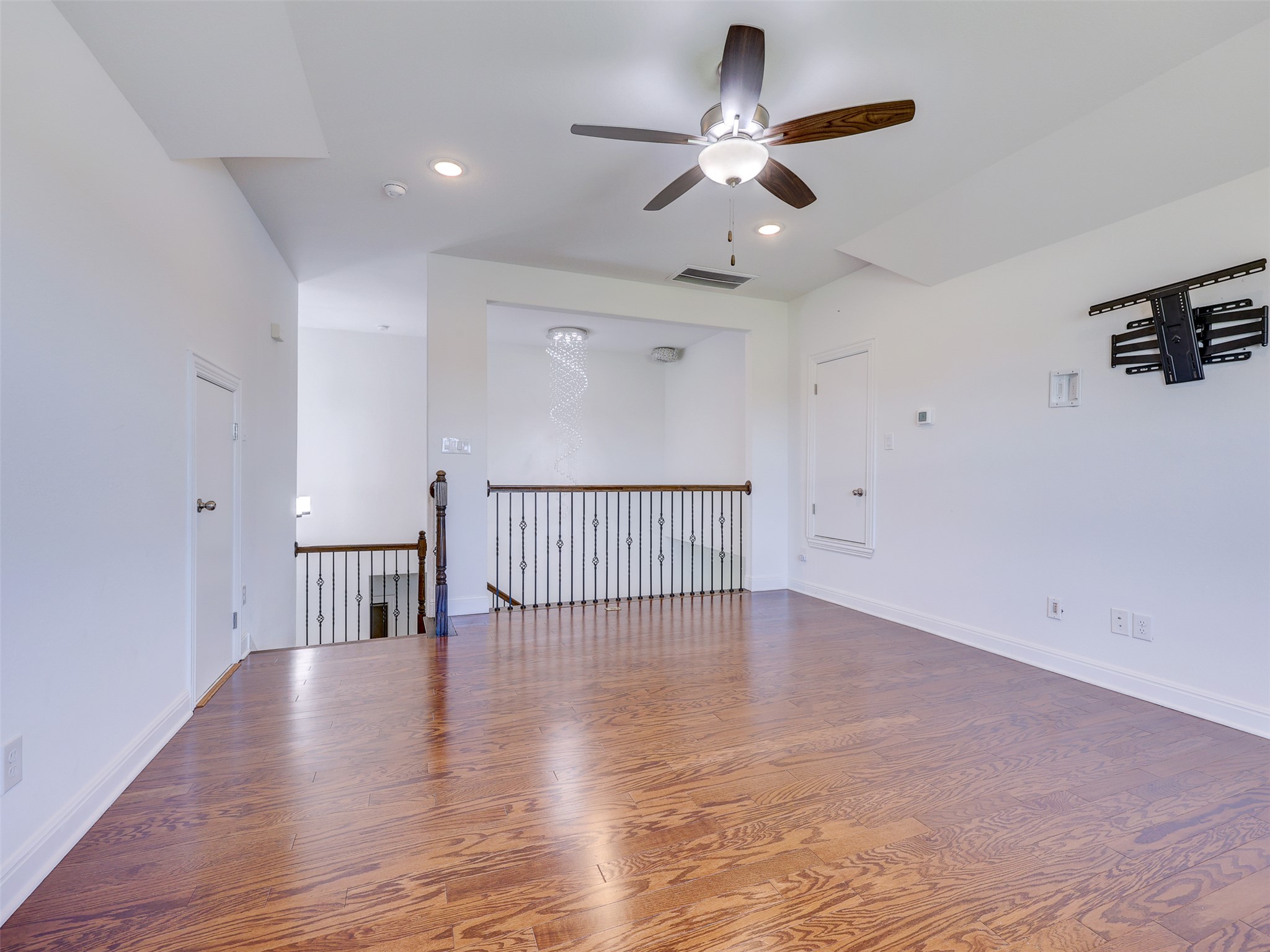 2020 Base Burner Path Leander, TX 78641 - Photo 17 of 22 Empty room with wood finished floors, a ceiling fan, and recessed lighting