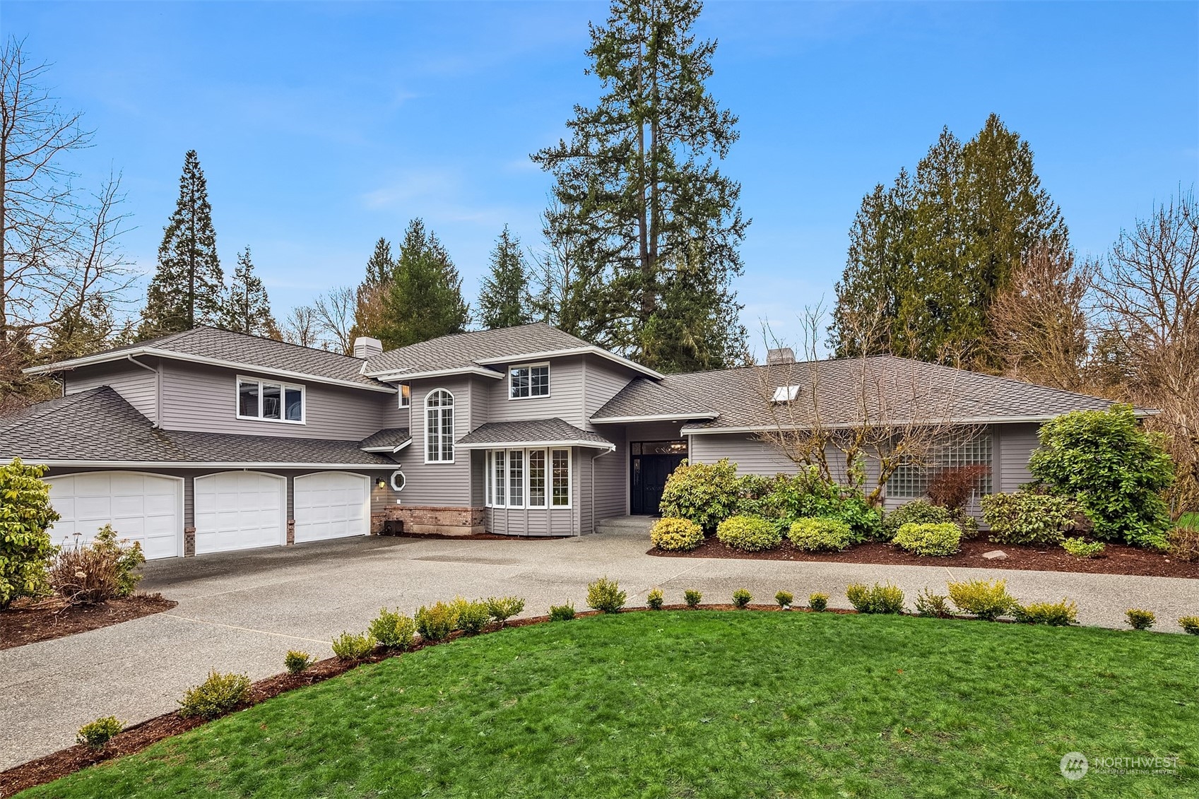 a front view of a house with a garden and plants